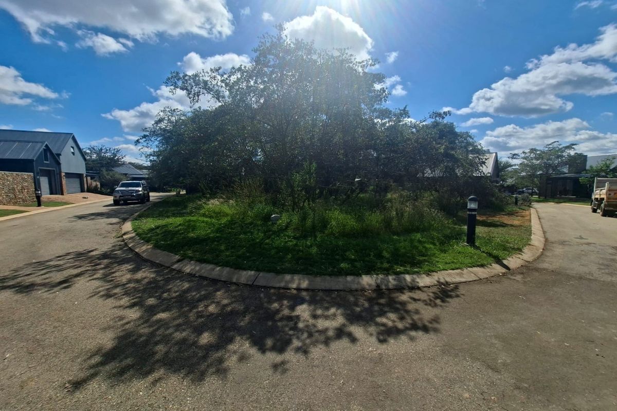 A view of a residential street cul-de-sac featuring paved roads, concrete curbing, and established landscaping within a residential estate.