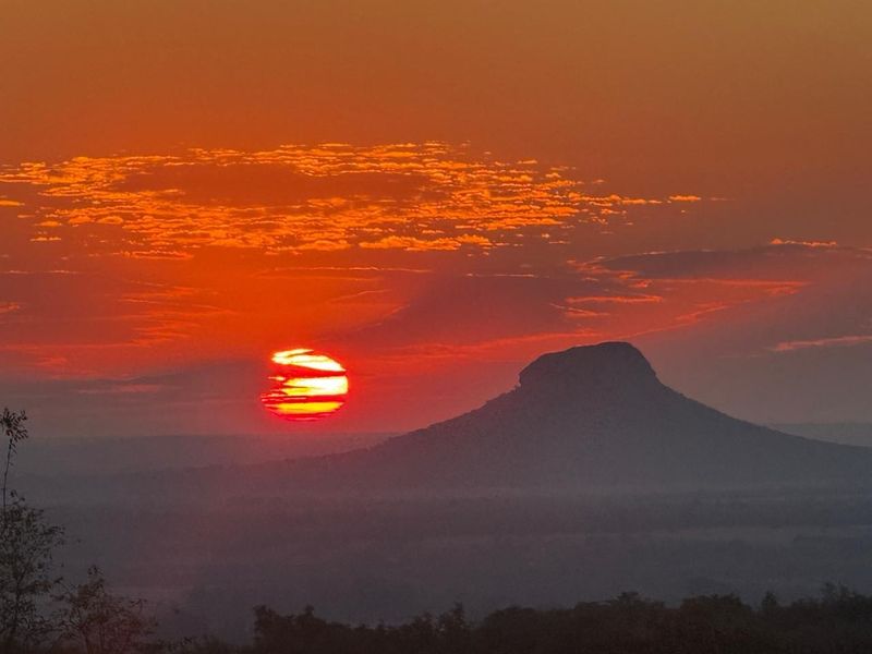 A scenic sunset view over the landscape, highlighting the natural beauty and horizon of the property area.