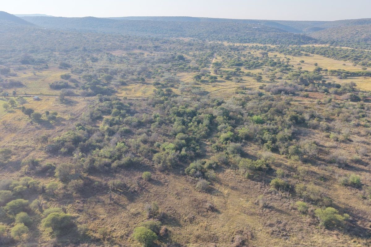 An aerial view of a large, undeveloped residential land plot featuring natural bushveld vegetation and rolling landscape.