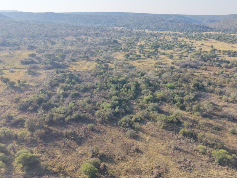 An aerial view of a large, undeveloped residential land plot featuring natural bushveld vegetation and rolling landscape.