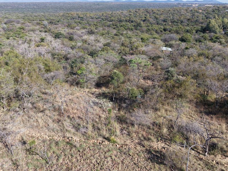 An aerial view of the expansive farm property featuring natural bushveld vegetation and established fencing.
