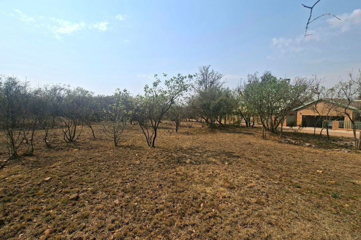 A view of the vacant residential land featuring established trees and open space, suitable for future development.