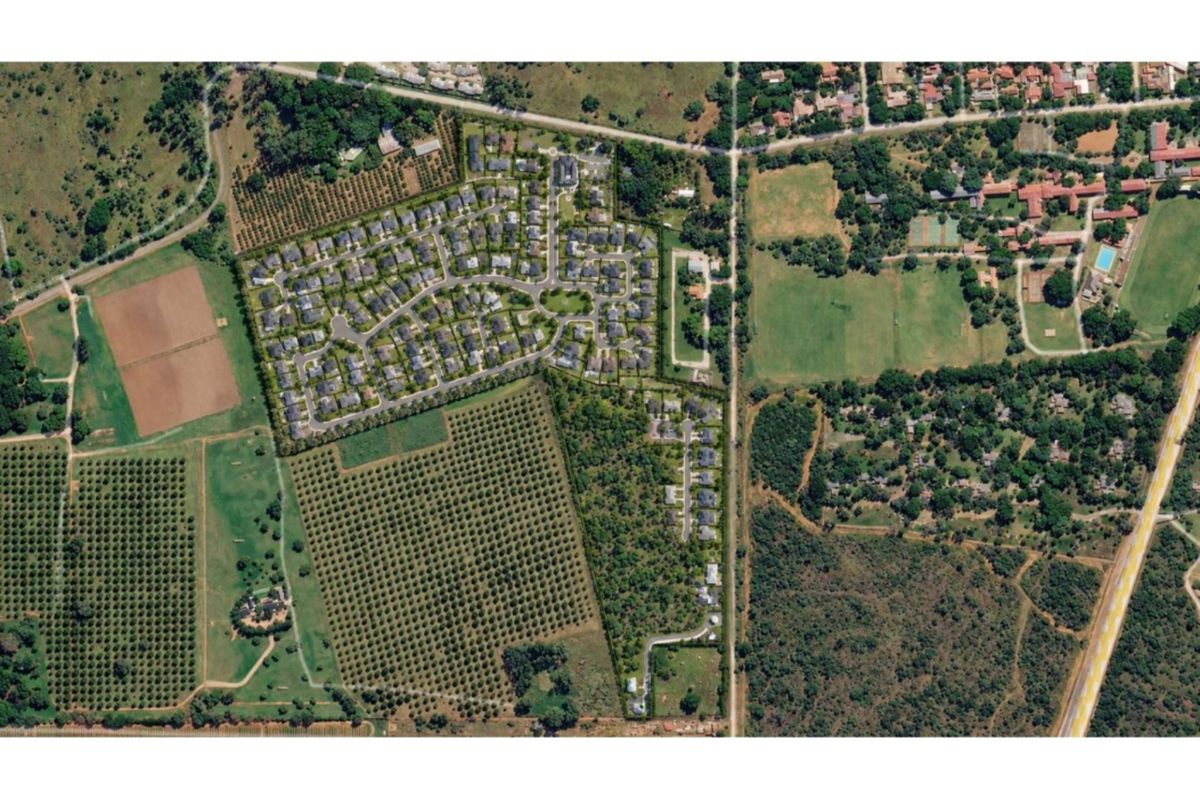 An aerial view of a residential estate development surrounded by orchards and natural landscape, showcasing the layout and surrounding environment.