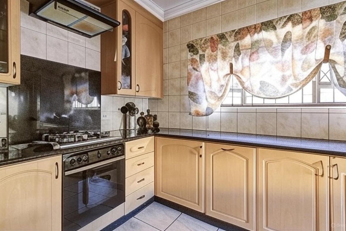 A functional kitchen featuring light wood cabinetry, dark granite countertops, a built-in oven with gas hob, and tiled finishes throughout.