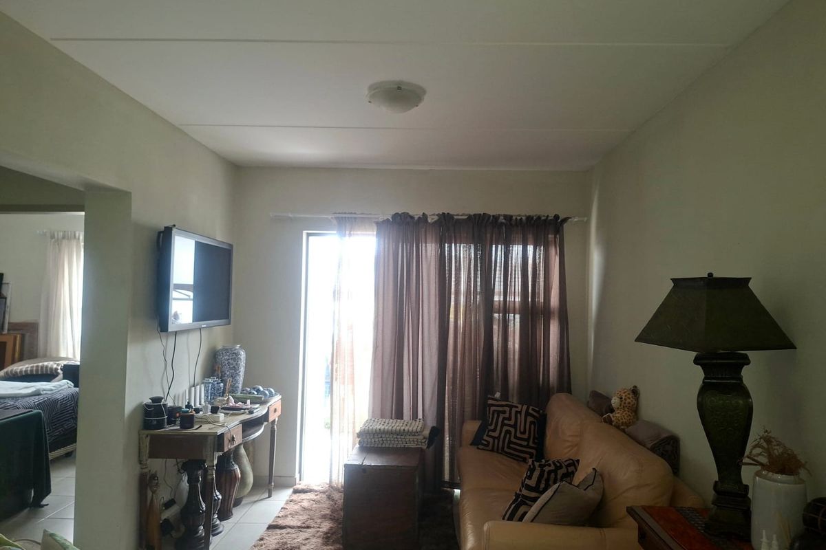 A living room area featuring a sliding glass door providing natural light and access to the exterior.