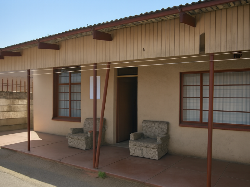 Front facade featuring a covered patio area with tiled flooring, metal support posts, and aluminium-framed windows under a corrugated metal roof.