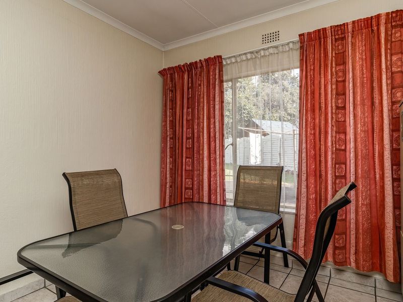 A functional dining area featuring tiled flooring and a coved ceiling, providing a practical space for meals.