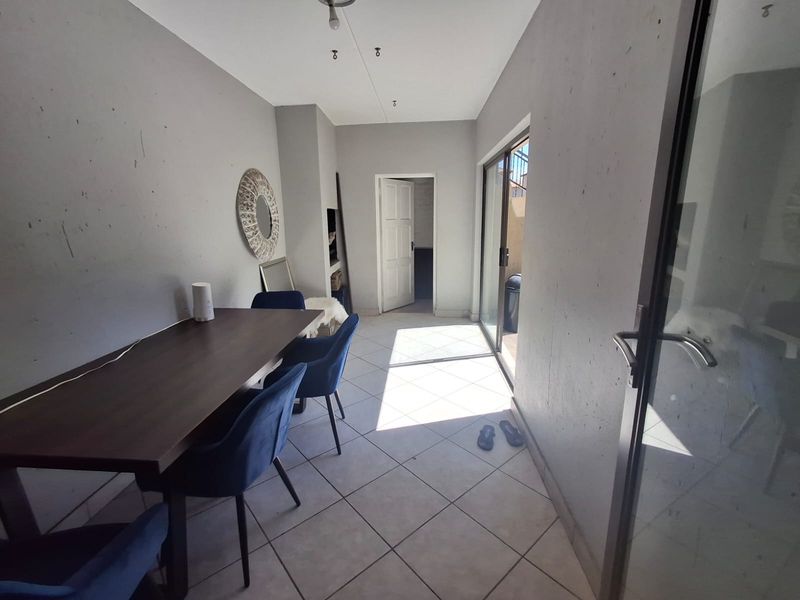 Dining area featuring tiled flooring and a sliding glass door providing access to an outdoor space.