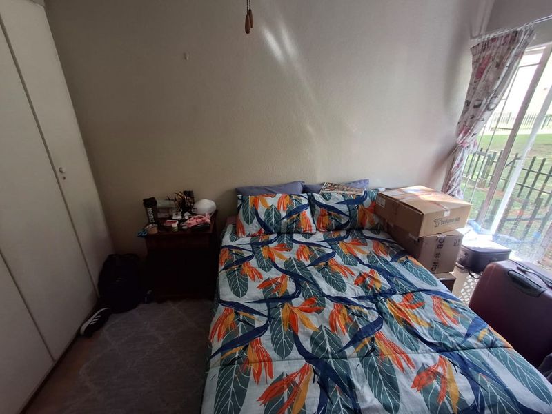 A bedroom featuring a built-in wardrobe and a sliding glass door providing access to the exterior.