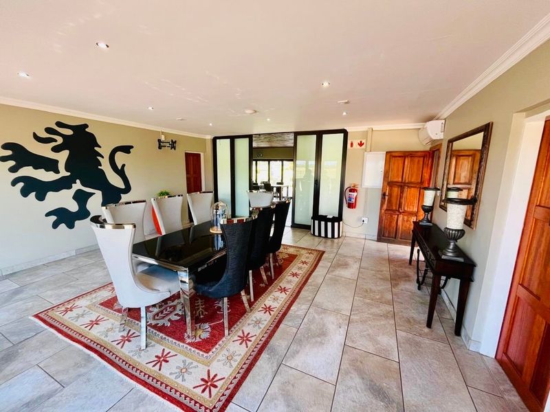 Spacious dining room featuring tiled flooring, recessed lighting, and sliding glass doors leading to an adjacent area, creating a bright and functional space.