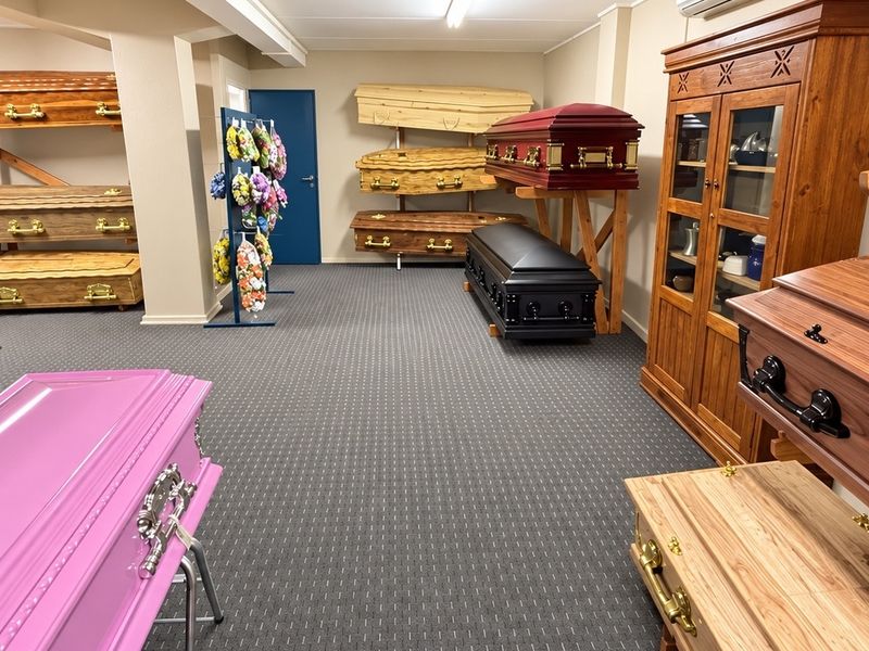 A well-maintained commercial showroom space featuring neutral wall finishes, carpeted flooring, and recessed lighting, currently utilized for display purposes.