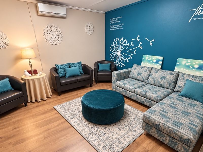 A well-maintained waiting or reception area featuring laminate flooring and a wall-mounted split-system air conditioning unit.