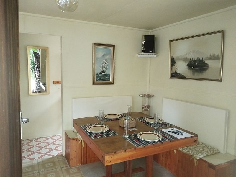Dining area featuring built-in bench seating and tiled flooring, providing a functional space for meals.