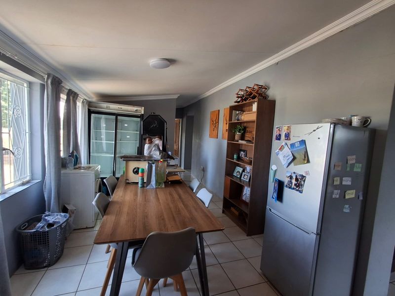 Open plan living and dining area featuring tiled flooring and neutral wall finishes, providing a functional space for daily living.