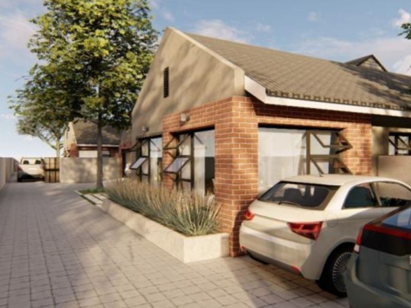 A modern residential exterior view featuring a brick facade, tiled roof, and a paved driveway leading to the property entrance.