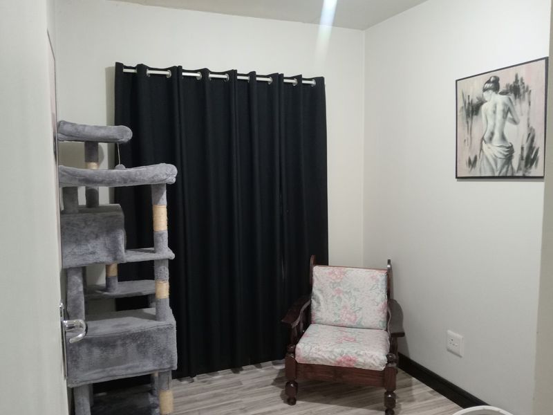 A bedroom featuring laminate flooring and neutral wall finishes, providing a blank canvas for personalization.