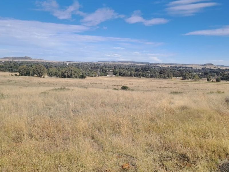 A wide-angle view of the expansive rural landscape and open fields surrounding the property.