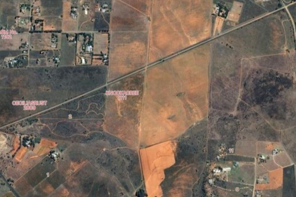 An aerial satellite view of the farm property showing the surrounding landscape and land boundaries.
