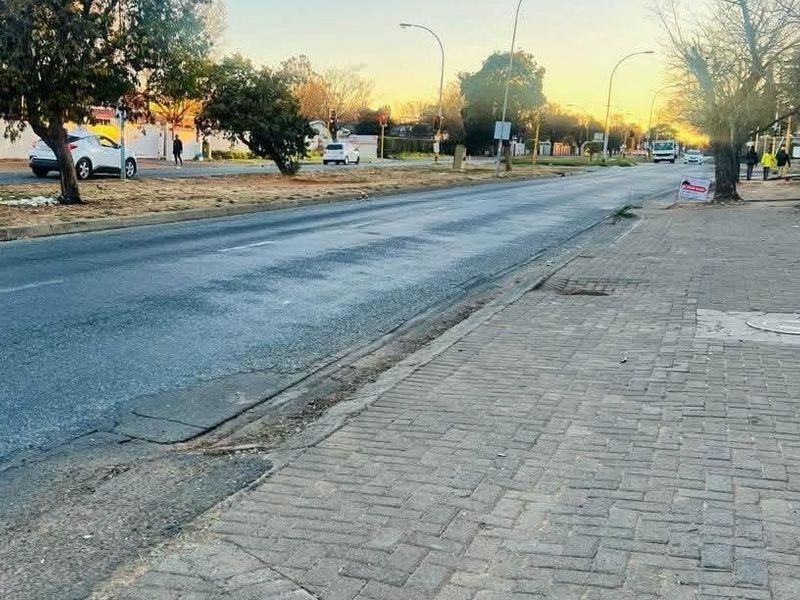 A view of the street and paved sidewalk adjacent to the property, showing the surrounding neighbourhood approach.