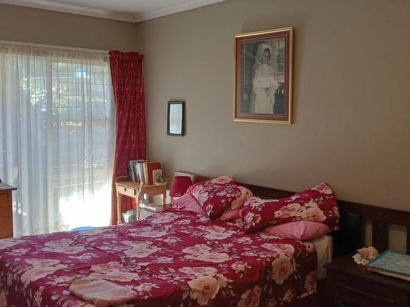 A bedroom featuring a sliding glass door providing natural light and access to the exterior.