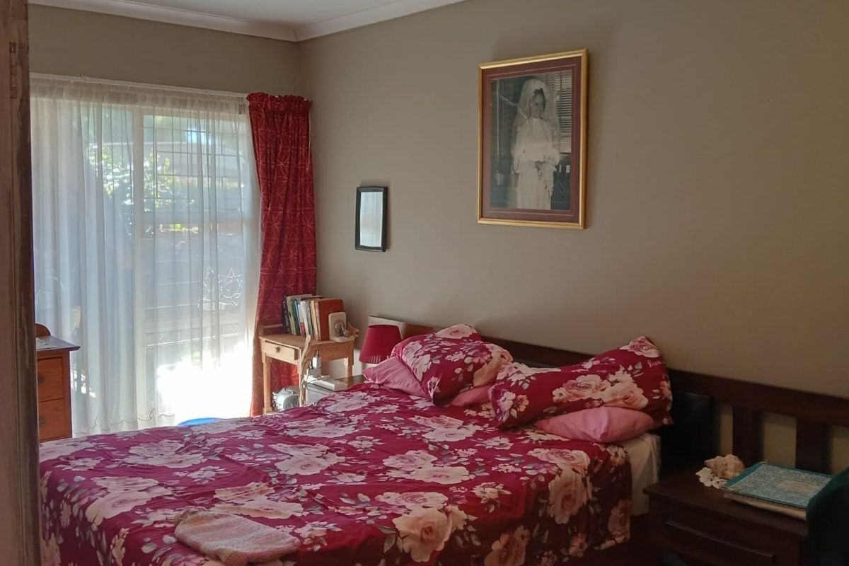 A bedroom featuring a sliding glass door providing natural light and access to the exterior.