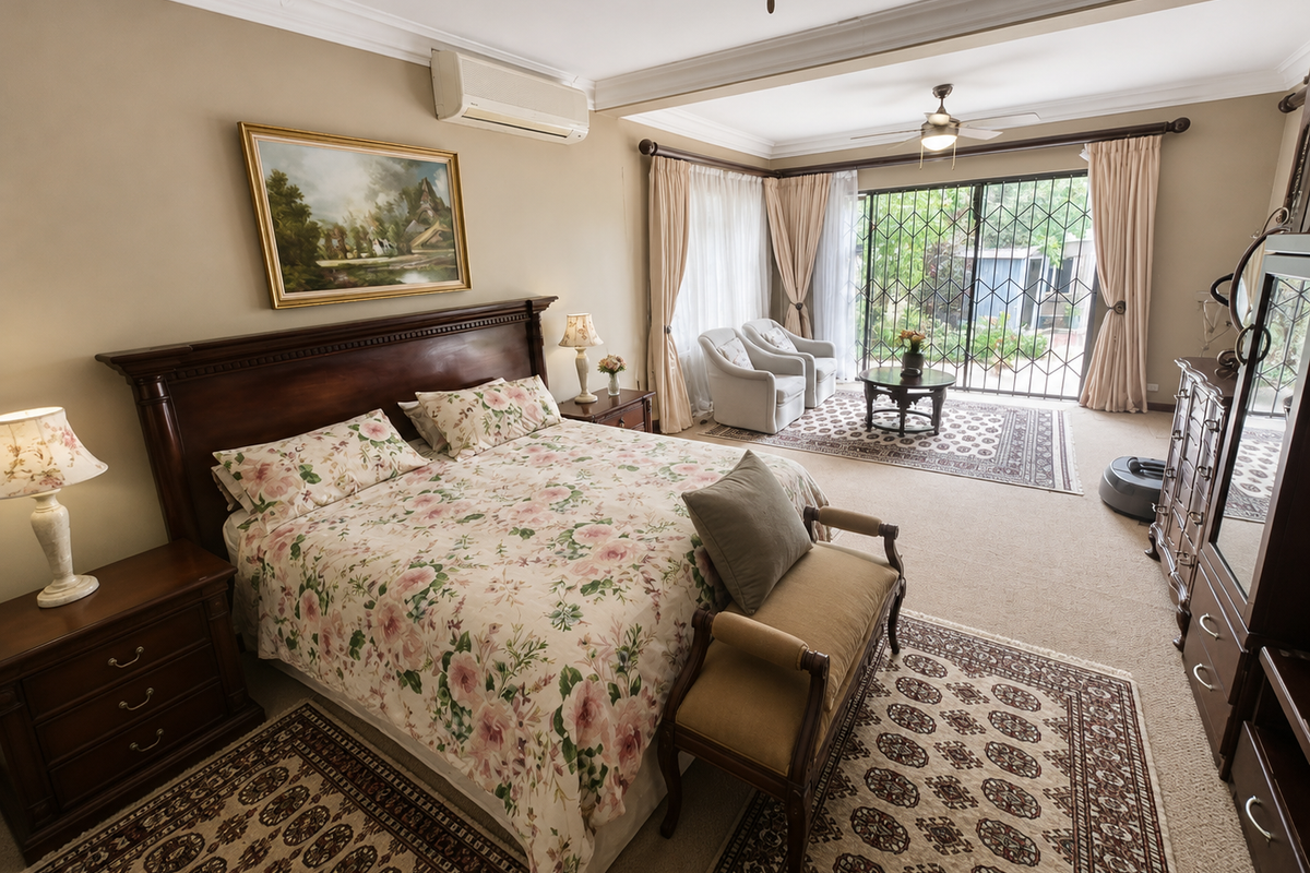 Spacious bedroom featuring crown molding, a split-system air conditioner, ceiling fan, and sliding glass doors leading to an outdoor area with security gates.