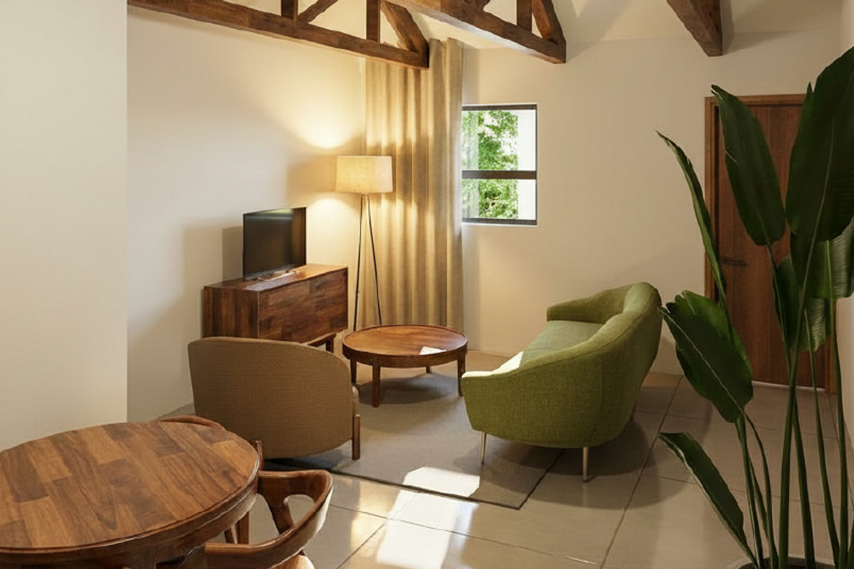A cozy living area featuring exposed timber ceiling beams, tiled flooring, and a warm, inviting atmosphere with natural light.