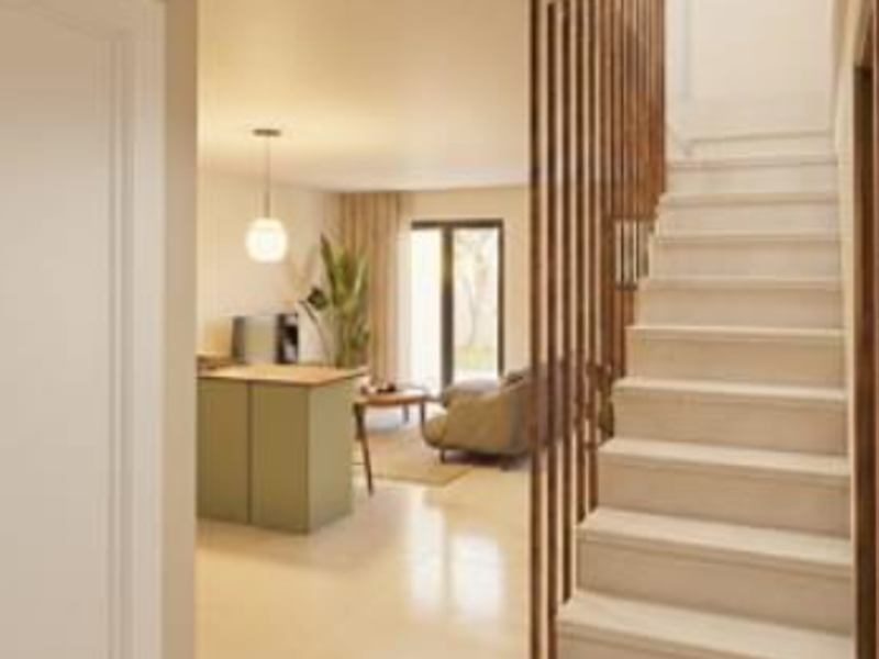 Modern open-plan living area featuring a contemporary staircase with timber slat balustrade, tiled flooring, and seamless access to the outdoor space.