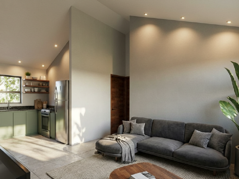 Modern open-plan living area featuring a sleek kitchen with built-in appliances, vaulted ceilings, recessed lighting, and large format tiled flooring.