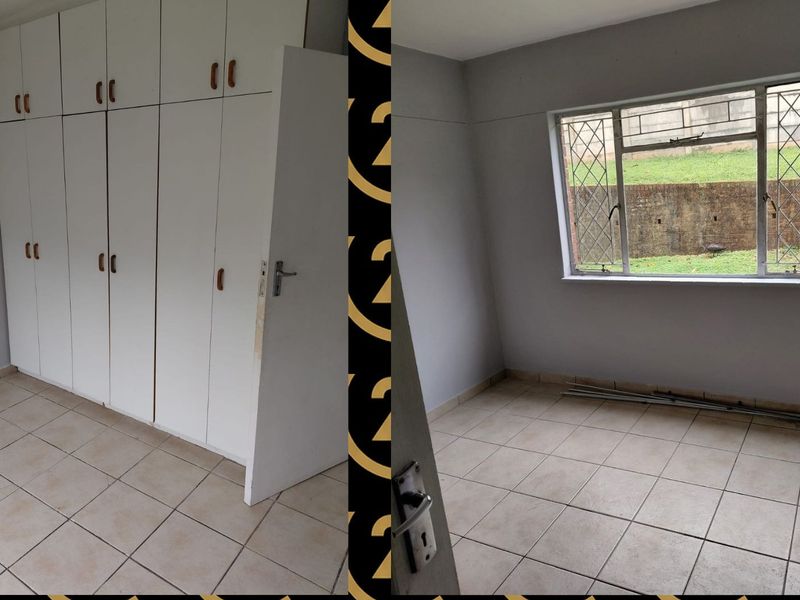 An empty bedroom featuring tiled flooring and built-in cupboards, with security bars on the window.