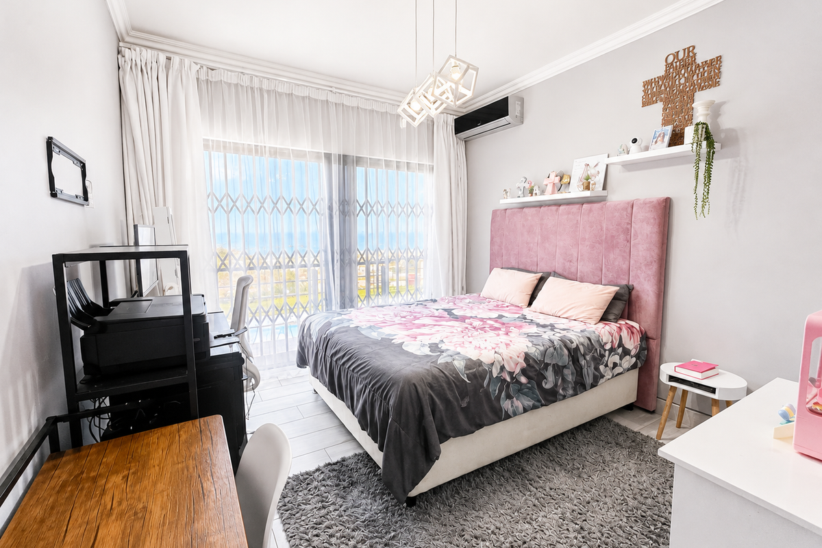 A well-maintained bedroom featuring tiled floors, crown molding, a split-system air conditioner, and a sliding glass door with security gate leading to a balcony.
