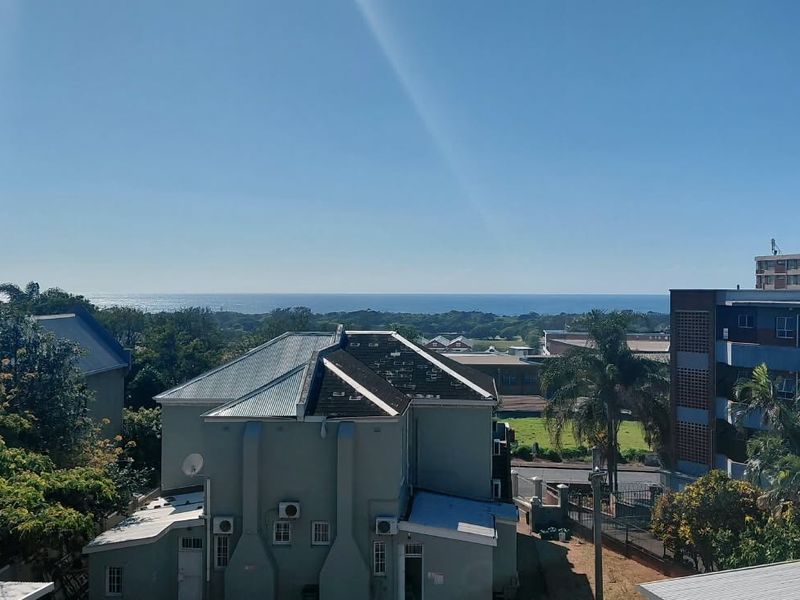 A scenic elevated view overlooking the surrounding neighborhood with a clear horizon line and distant ocean view.