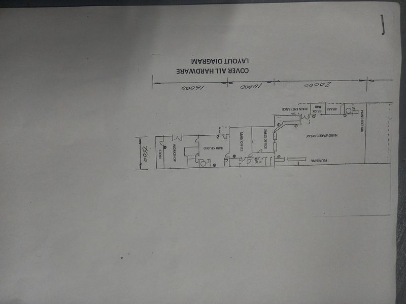 A layout diagram of the commercial property showing the arrangement of various sections including offices, workshop, and hardware display areas.