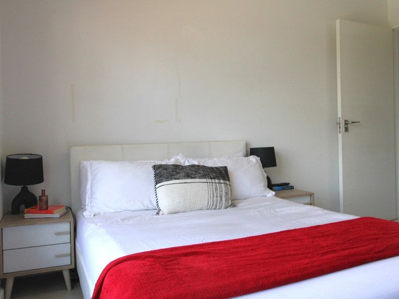 A simple bedroom featuring neutral walls and a standard internal door, providing a functional space ready for personalization.