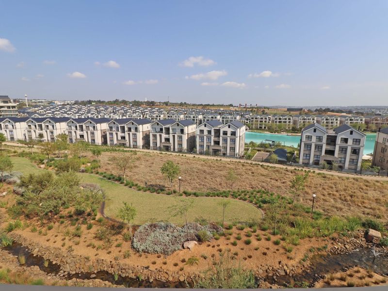An elevated aerial view showcasing the residential estate, landscaped grounds, and surrounding neighborhood infrastructure.