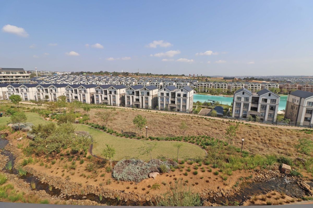 An elevated aerial view showcasing the residential estate, landscaped grounds, and surrounding neighborhood infrastructure.