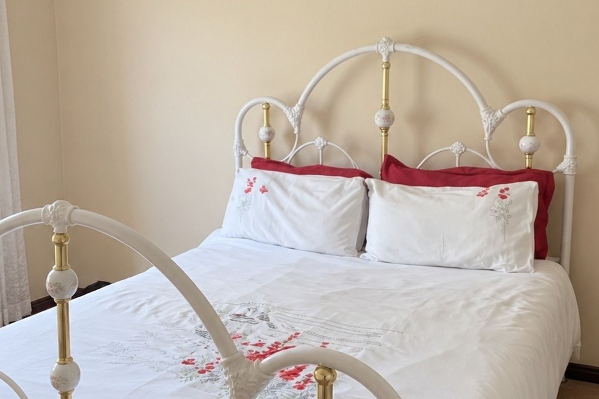 A bedroom featuring neutral wall finishes and a curtain rail, providing a clean and functional space.