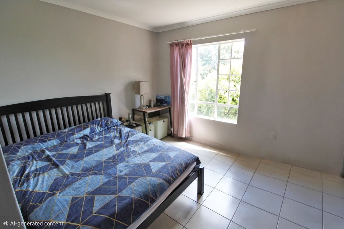 A bedroom featuring tiled flooring, a grid-pattern window, and coved ceiling details, offering a functional space with natural light.