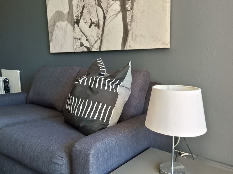 A close-up view of a living room area featuring dark grey painted walls.