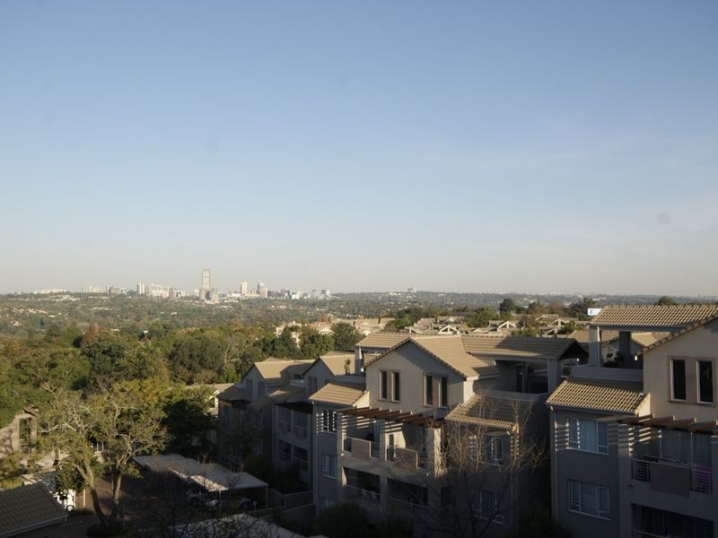 An elevated panoramic view overlooking the surrounding residential estate and distant city skyline.