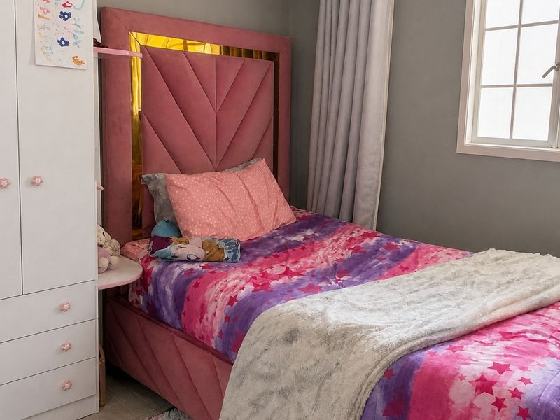 A well-maintained bedroom featuring a built-in wardrobe and a window with natural light.