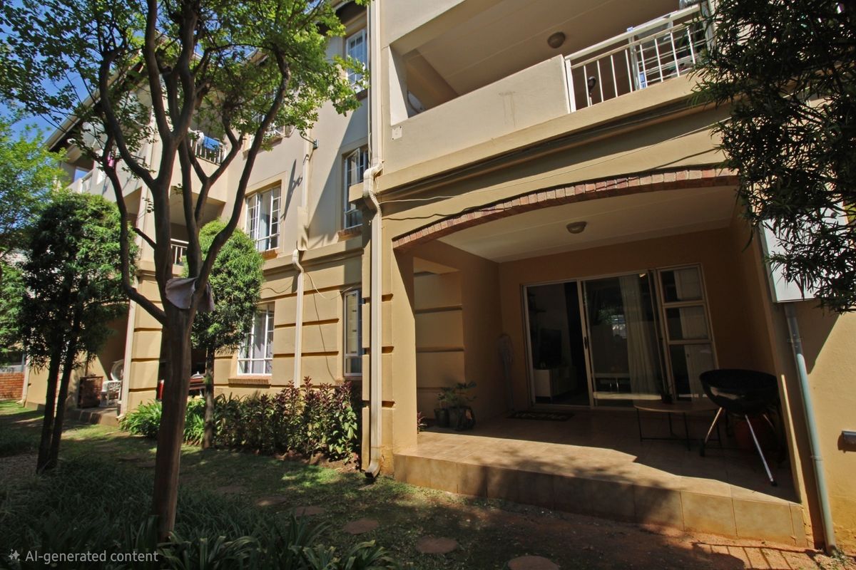 Rear view of the apartment building featuring a ground-floor covered patio with sliding door access and an upper-level balcony.