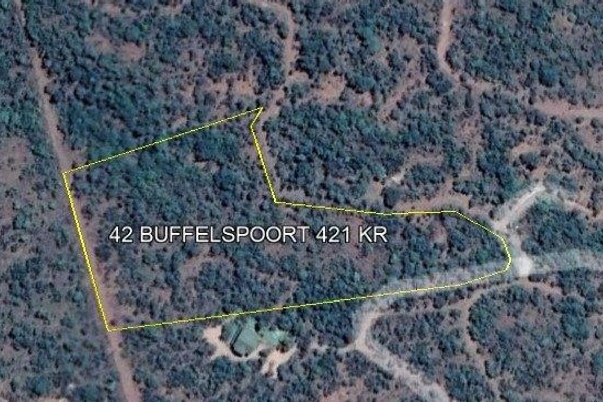 An aerial view of the vacant residential land plot, showing the property boundaries and surrounding natural vegetation.