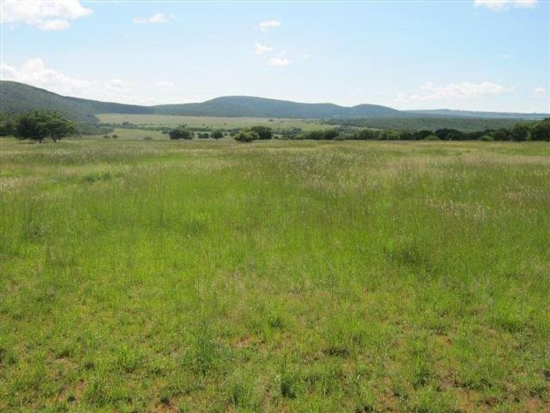 Expansive vacant residential land featuring natural grassland and scenic mountain views, offering a peaceful setting for future development.