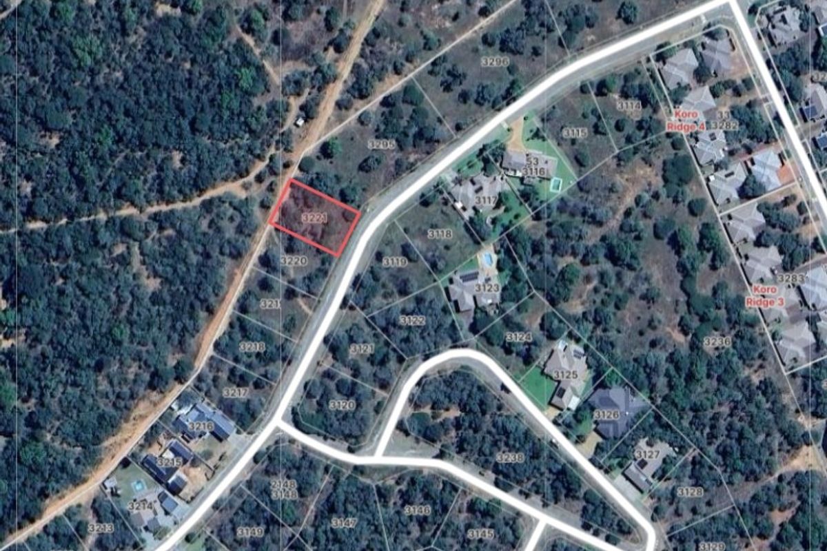 Aerial view of a vacant residential plot in a developed estate, highlighting the property boundaries and surrounding neighborhood layout.