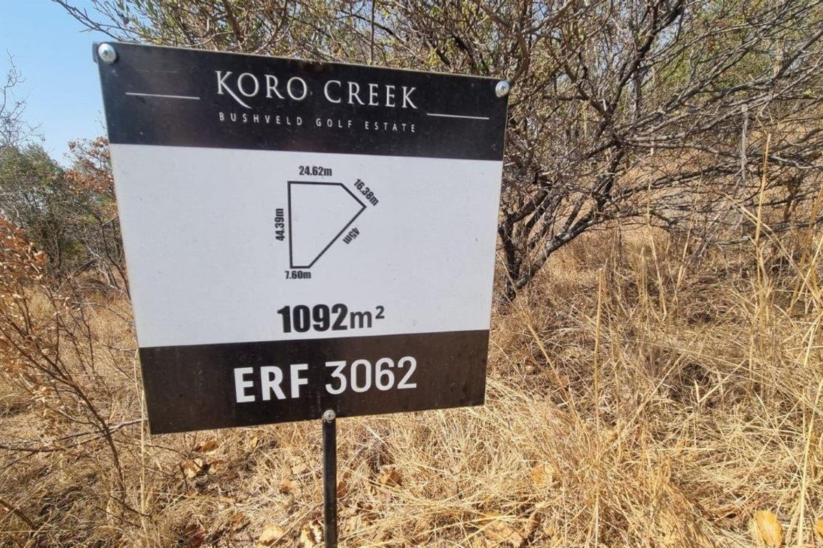 A clear signage board displaying the erf number, total land area of 1092m2, and boundary dimensions for the residential vacant land plot.