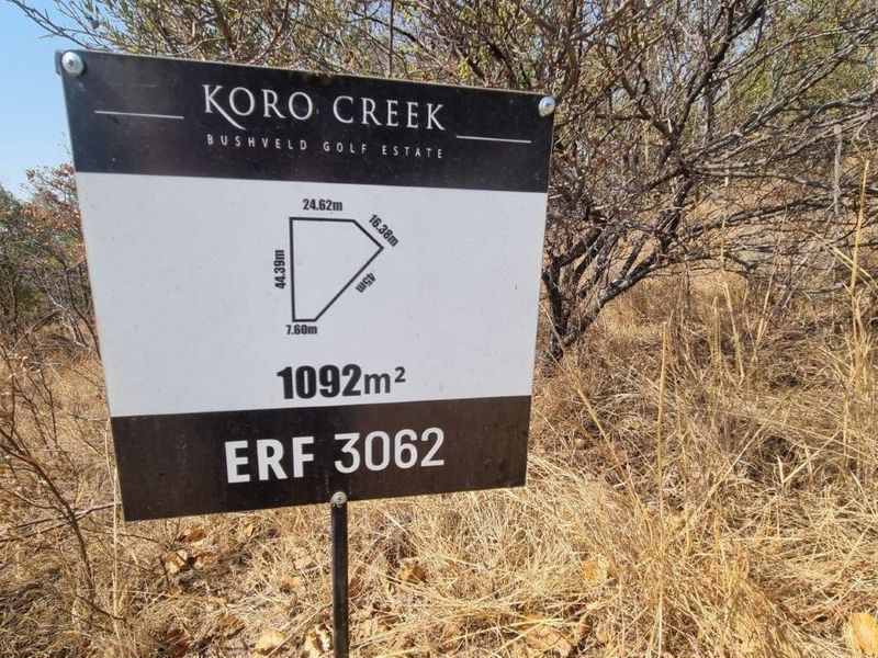 A clear signage board displaying the erf number, total land area of 1092m2, and boundary dimensions for the residential vacant land plot.