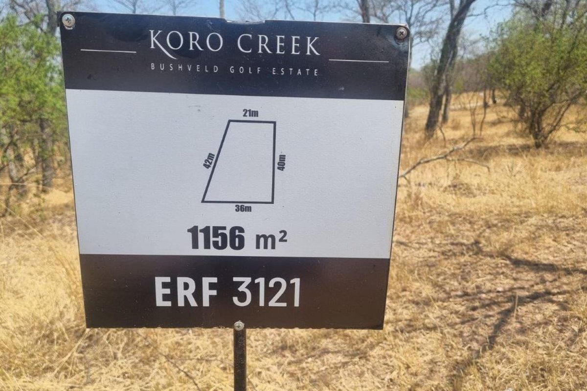 A signage board displaying the dimensions and details of a 1156 square meter residential vacant land plot in Koro Creek Bushveld Golf Estate.