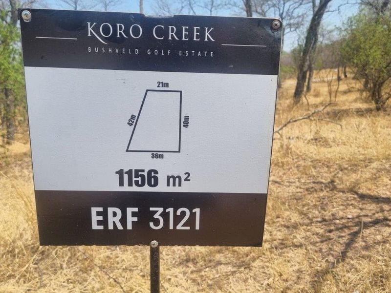 A signage board displaying the dimensions and details of a 1156 square meter residential vacant land plot in Koro Creek Bushveld Golf Estate.