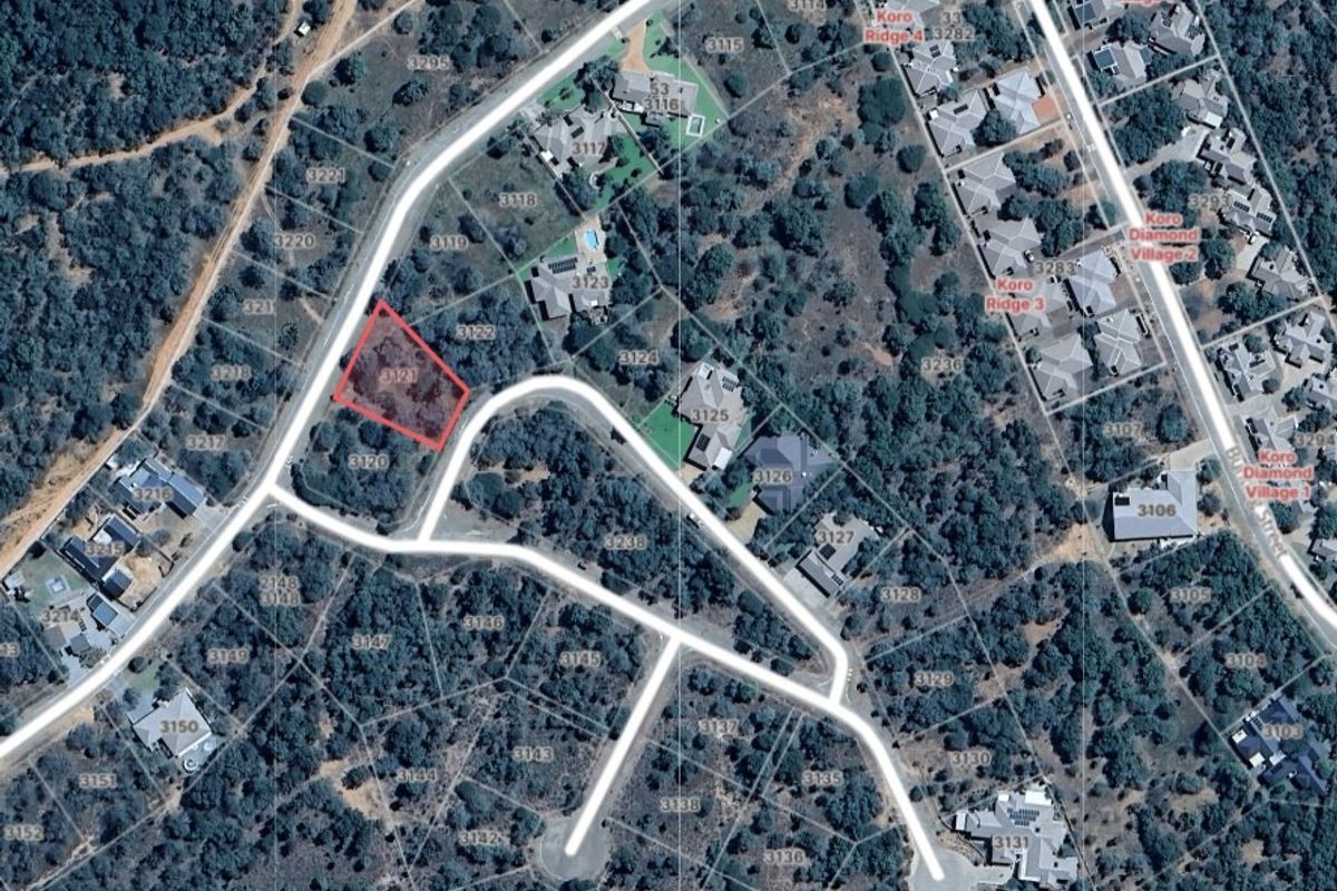 Aerial view of a vacant residential plot within a developed estate, highlighting its location, road access, and surrounding landscape.